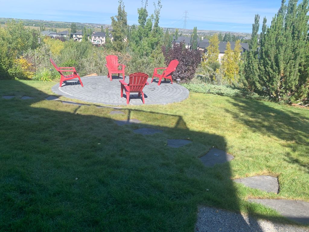 charcoal calgary landscaping backyard raised paving stones fire pit patio
