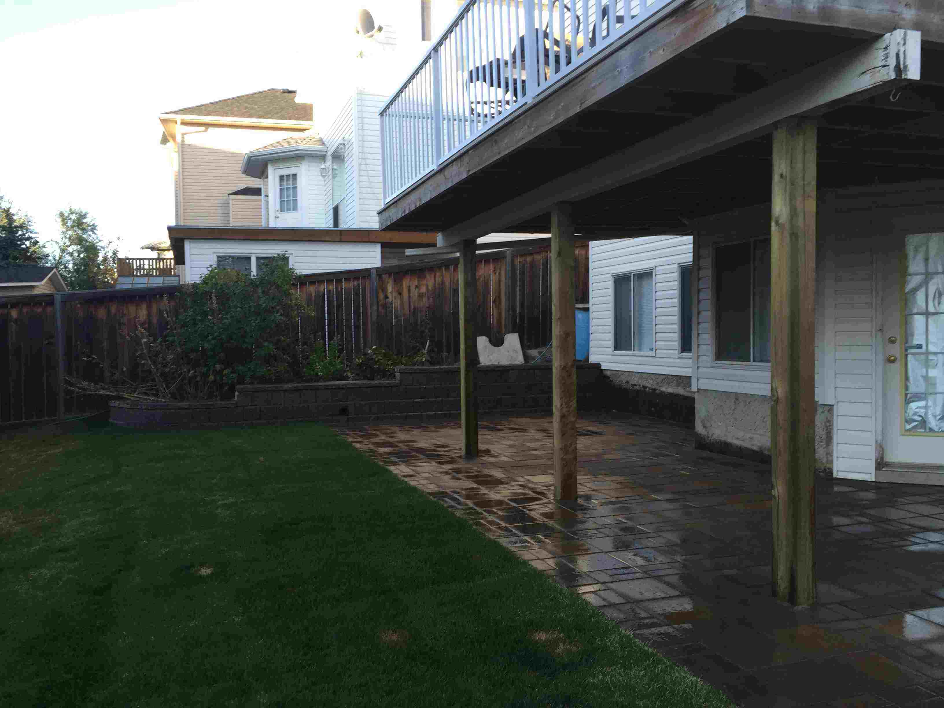 complete landscaping Calgary backyard, side yard, front yard paving stone patio, with retaining walls and fix drainage water issue